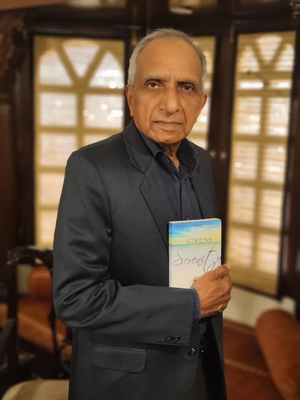 Amar Singh Chandel holding his book Stress to Serenity
